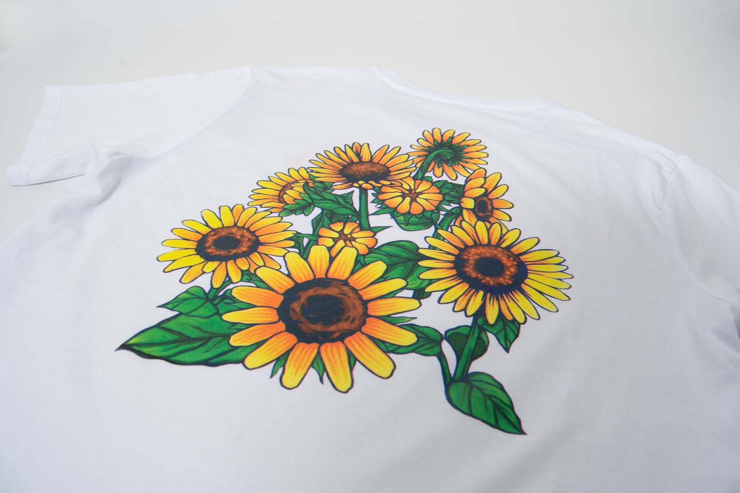 Disfruta de esta camiseta de edición limitada. Tejido de algodón orgánico y estampación con serigrafía manual mediante técnica de cuatricromía. Su diseño colorido de girasoles seguro que te alegra un poquito el día.  Tejido de 150gr/m2, cómodas y suaves para uso habitual.  100% Algodón Orgánico